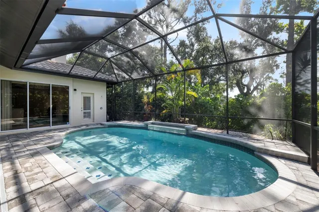 an aerial view of residential houses with outdoor space and trees
