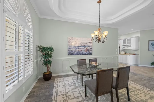 a dining room with furniture and wooden floor