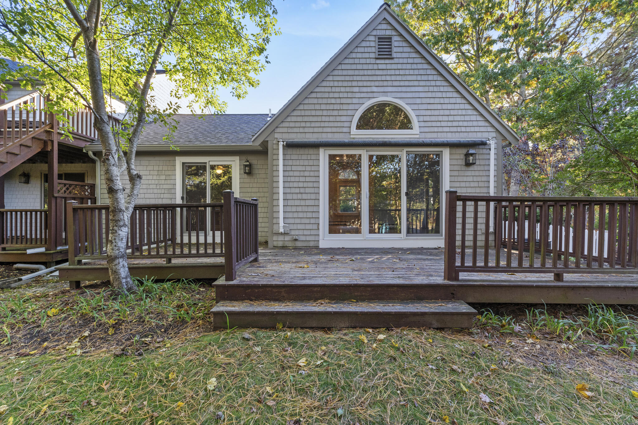 a view of a house with a yard and furniture