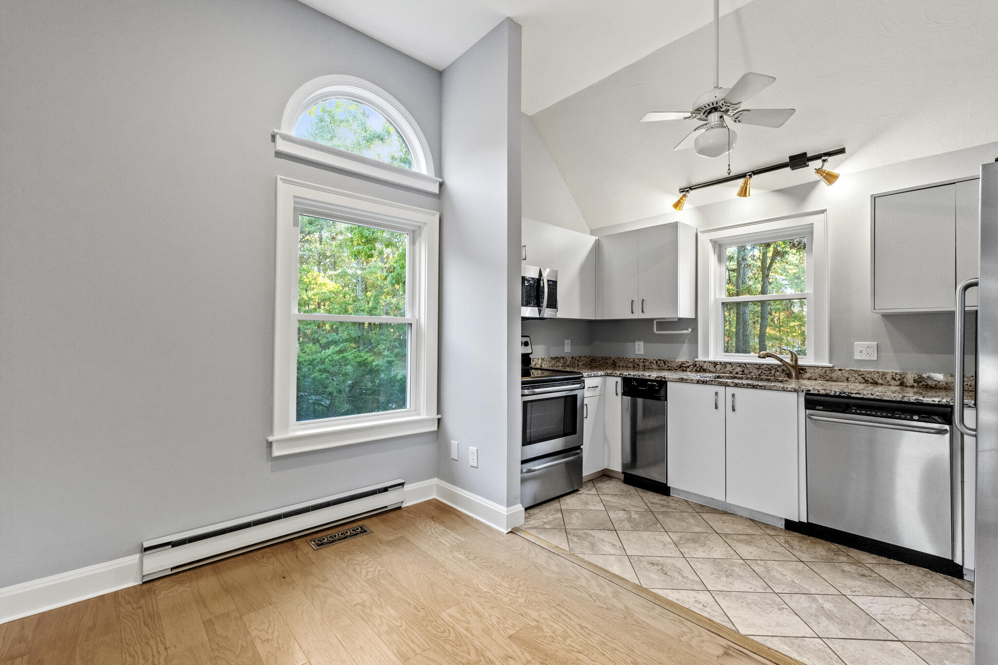 24 Ryan's Way, Unit 6 Mashpee, MA 02649 - Photo 7 of 23 a kitchen with a stove a sink and a window