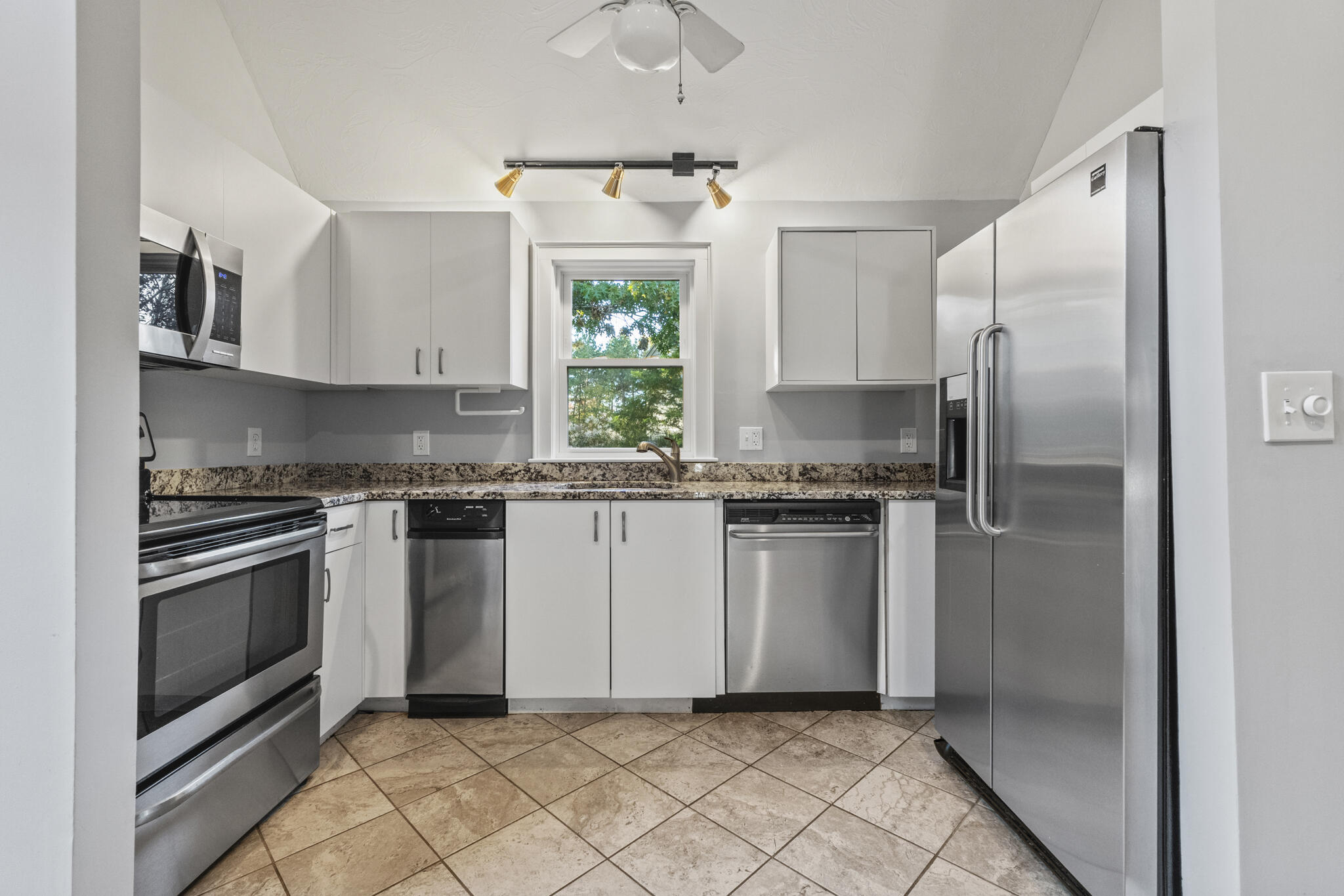 24 Ryan's Way, Unit 6 Mashpee, MA 02649 - Photo 8 of 23 a kitchen with granite countertop white cabinets stainless steel appliances and a window