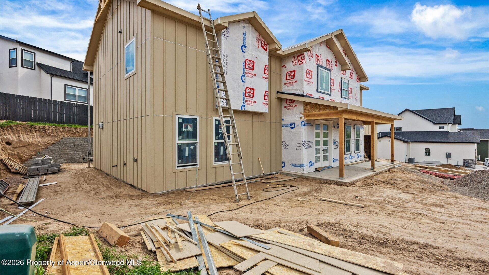 1384 Munro Avenue Rifle, CO 81650 - Photo 2 of 38 a view of a white house with large windows and wooden fence