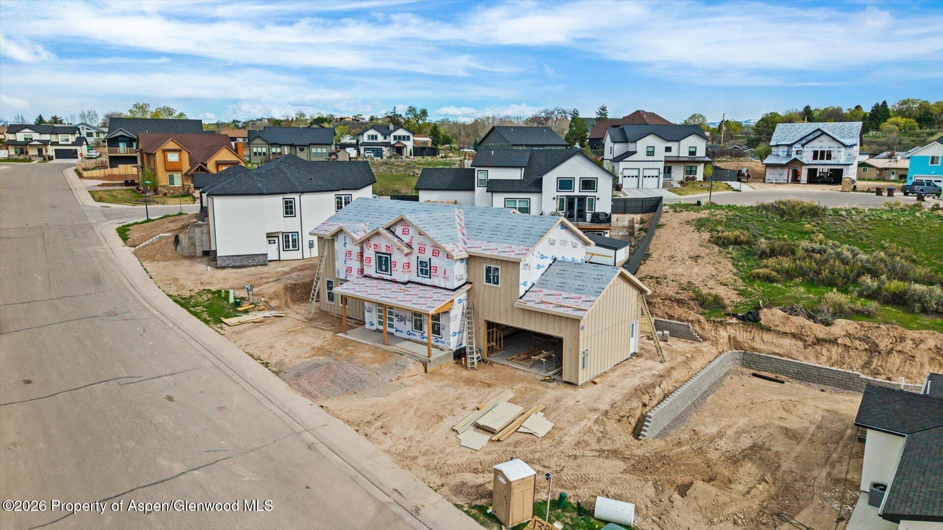 1384 Munro Avenue Rifle, CO 81650 - Photo 6 of 38 an aerial view of a house with a garden and mountain view in back