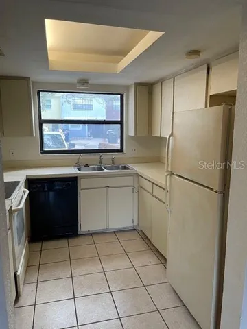 a kitchen with a stove a refrigerator and a oven