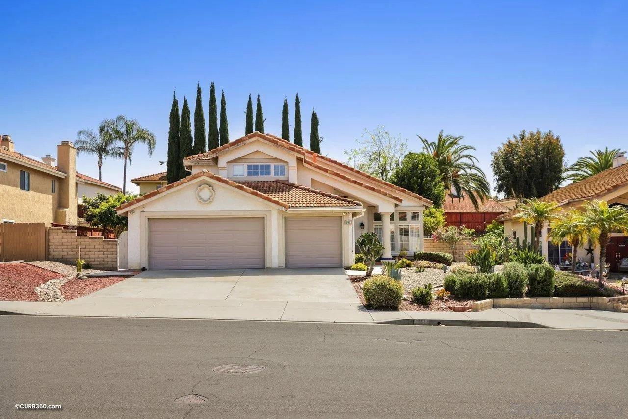 5138 Vía Madrid Oceanside, CA 92057 - Photo 1 of 32 a front view of a house with a yard and garage
