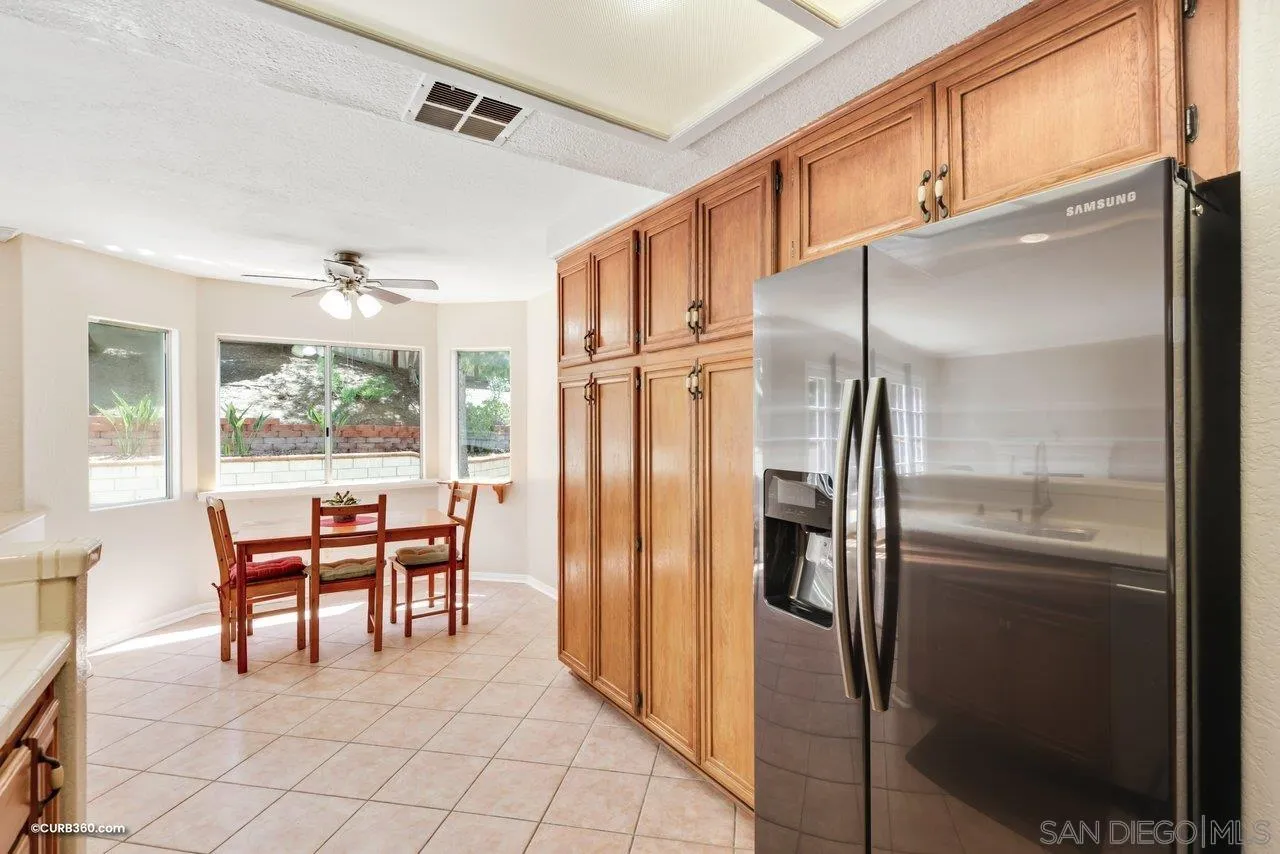 5138 Vía Madrid Oceanside, CA 92057 - Photo 12 of 32 a kitchen with stainless steel appliances granite countertop a refrigerator and cabinets