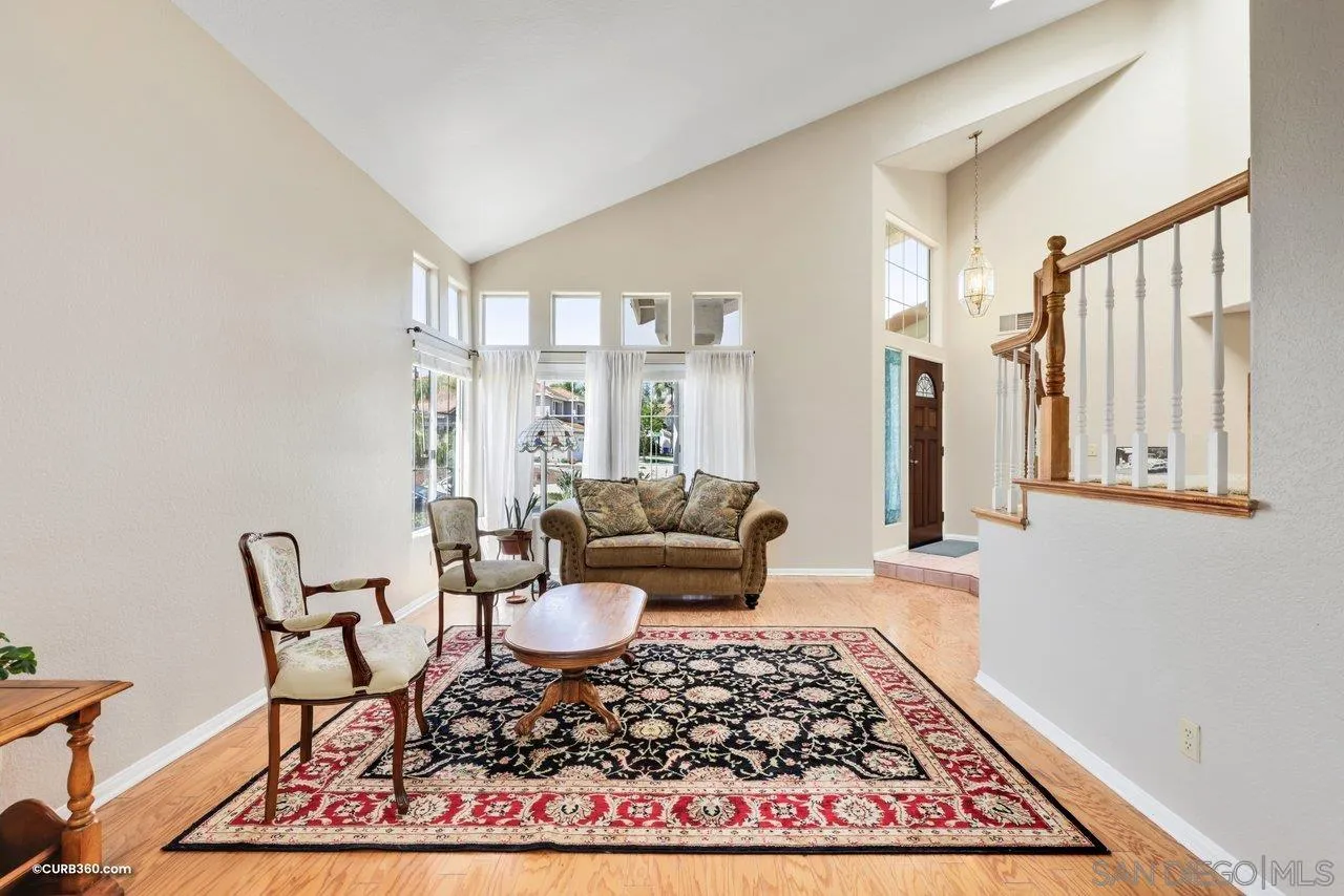 5138 Vía Madrid Oceanside, CA 92057 - Photo 8 of 32 a living room with rug couches and a table with wooden floor