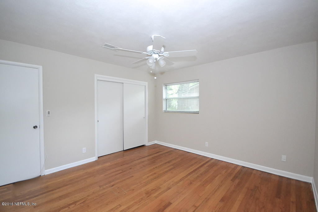 6638 West Fincannon Road Jacksonville, FL 32277 - Photo 14 of 27 wooden floor in an empty room with a window