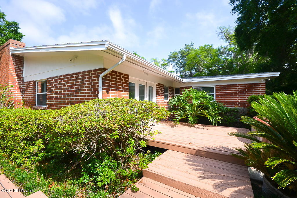 6638 West Fincannon Road Jacksonville, FL 32277 - Photo 20 of 27 a view of a house with a small yard and plants