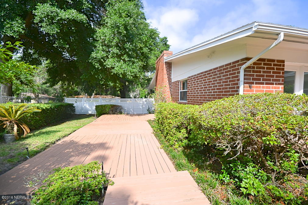 6638 West Fincannon Road Jacksonville, FL 32277 - Photo 21 of 27 a front view of a house with a yard