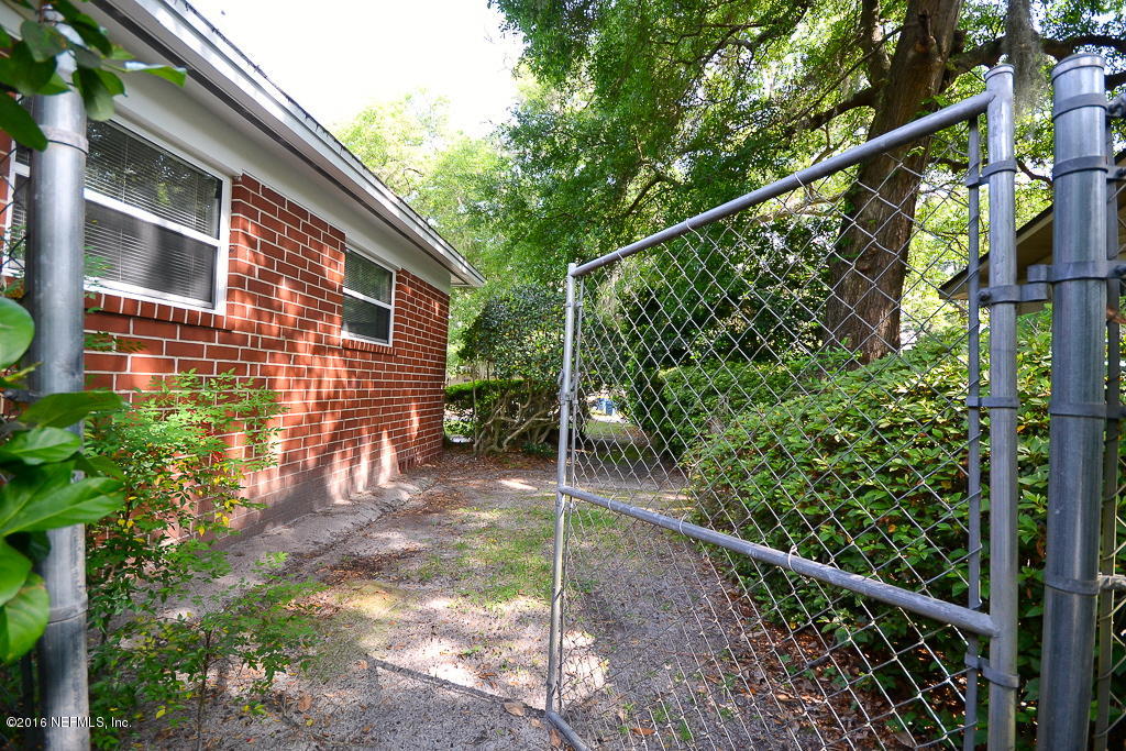 6638 West Fincannon Road Jacksonville, FL 32277 - Photo 23 of 27 a view of a chair and table in the backyard