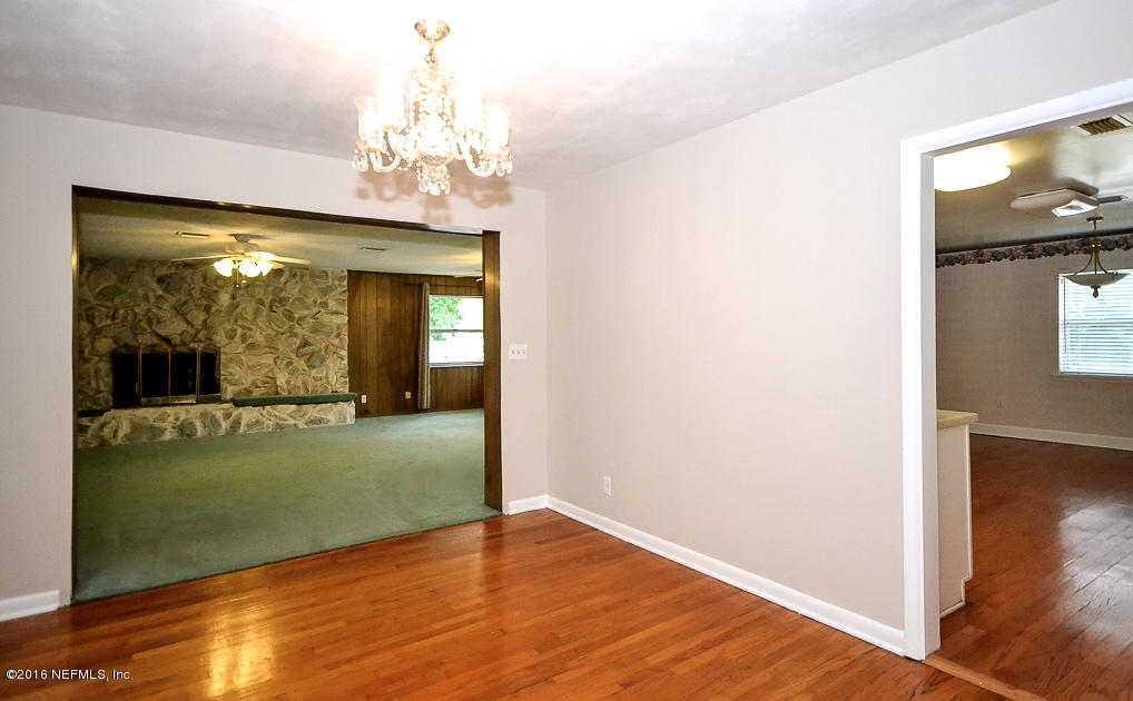 6638 West Fincannon Road Jacksonville, FL 32277 - Photo 4 of 27 a view of a room with wooden floor fan and windows