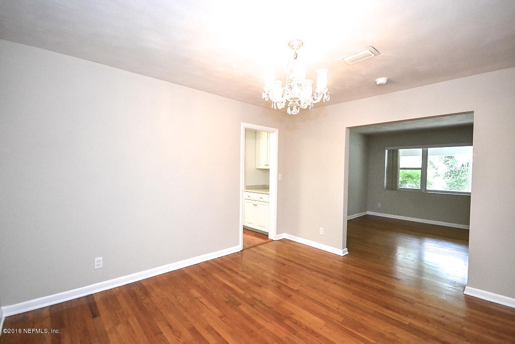 6638 West Fincannon Road Jacksonville, FL 32277 - Photo 5 of 27 wooden floor in an empty room with a window