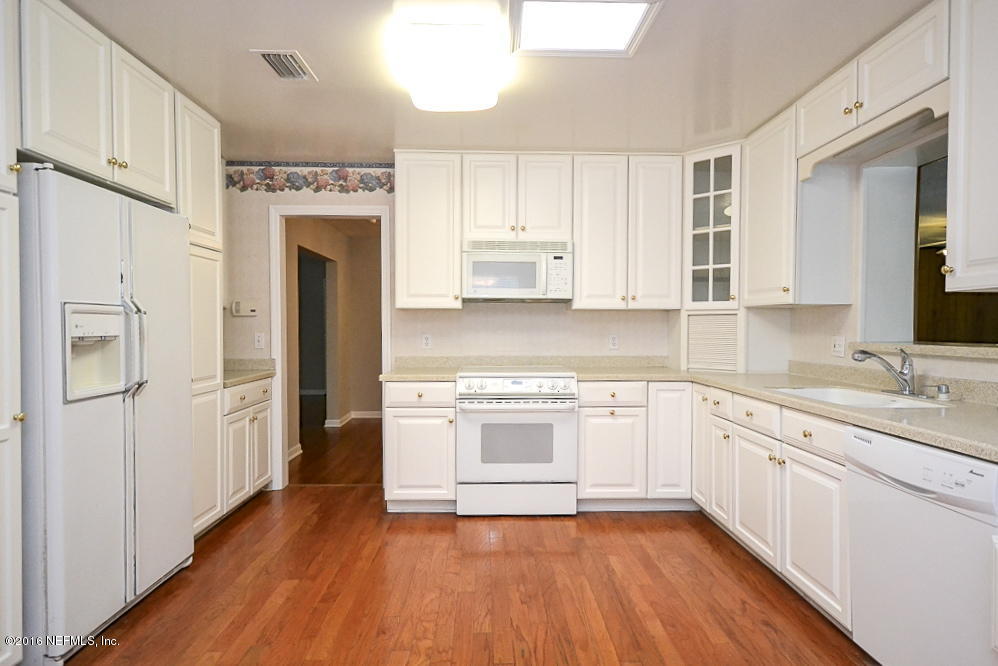 6638 West Fincannon Road Jacksonville, FL 32277 - Photo 8 of 27 a kitchen with a refrigerator sink and cabinets
