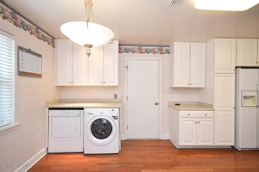 6638 West Fincannon Road Jacksonville, FL 32277 - Photo 9 of 27 a view of a kitchen with refrigerator and cabinets