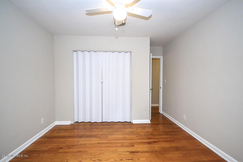 6638 West Fincannon Road Jacksonville, FL 32277 - Photo 10 of 27 a view of an empty room with wooden floor