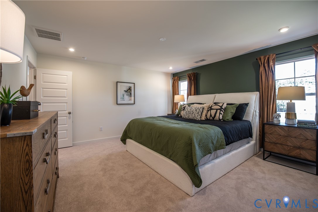 5318 Qualla Trace Chesterfield, VA 23832 - Photo 24 of 35 a bedroom with a large bed and a flat tv screen on dresser