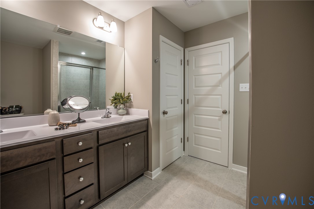 5318 Qualla Trace Chesterfield, VA 23832 - Photo 26 of 35 a bathroom with a double vanity sink and a mirror