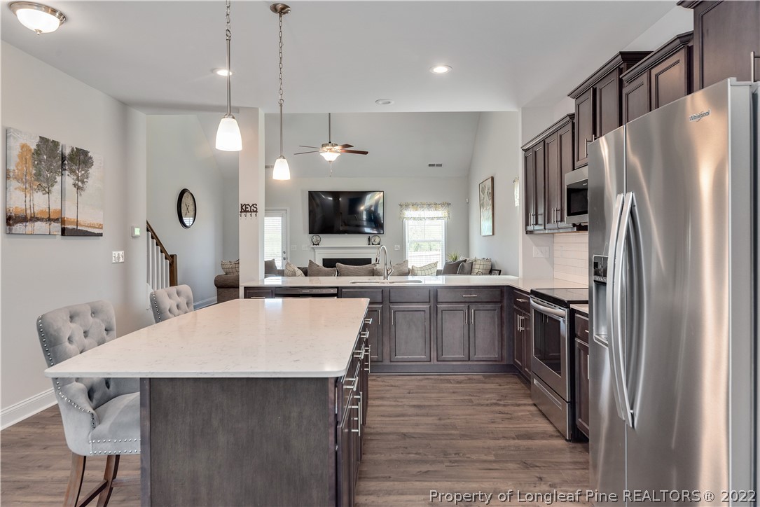 162 Trinity Road Raeford, NC 28376 - Photo 11 of 33 a kitchen with a table chairs refrigerator and microwave