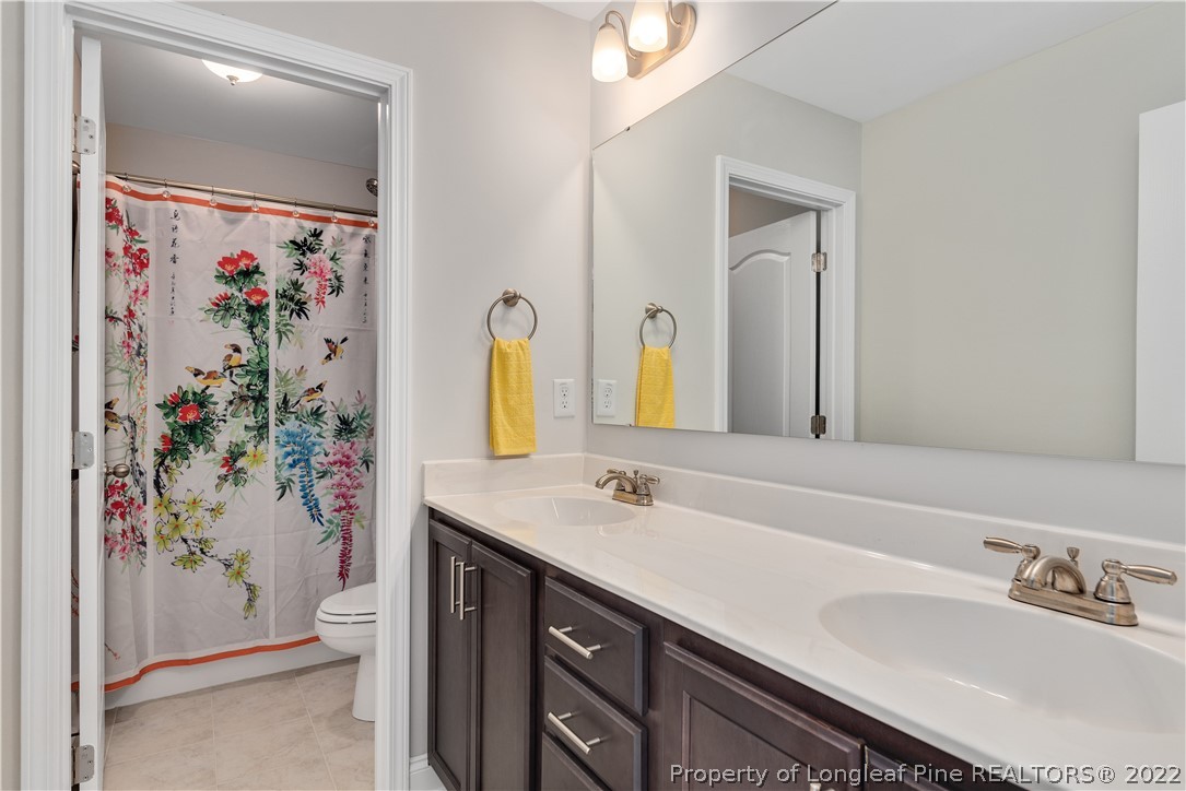 162 Trinity Road Raeford, NC 28376 - Photo 22 of 33 a bathroom with a sink a vanity and a mirror