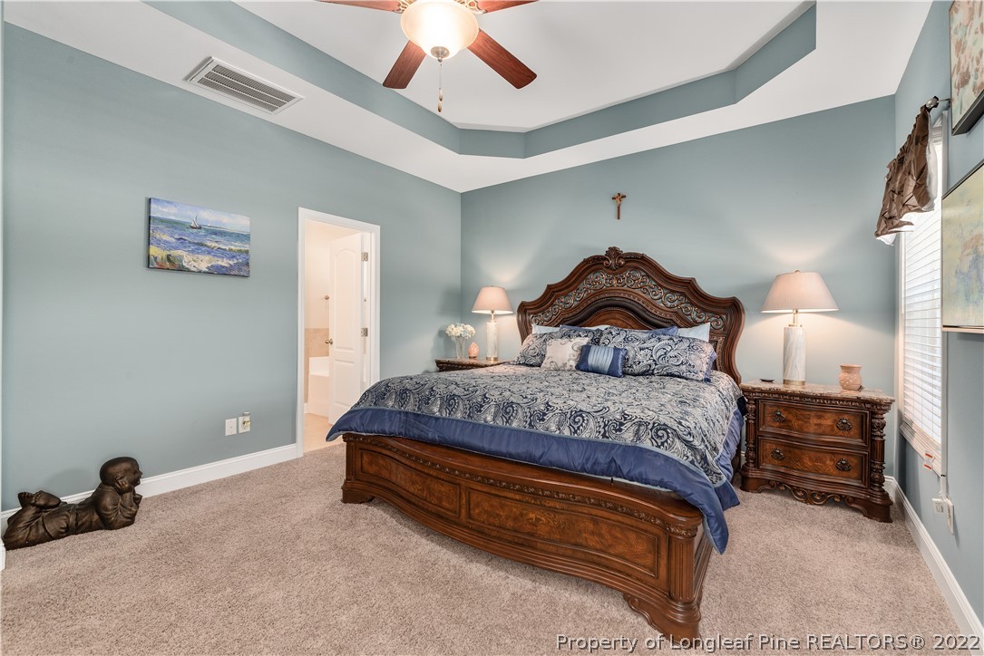 162 Trinity Road Raeford, NC 28376 - Photo 29 of 33 a bedroom with a bed and a chandelier