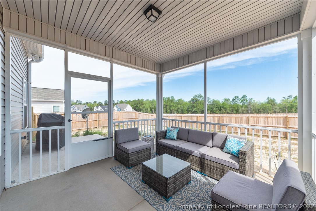162 Trinity Road Raeford, NC 28376 - Photo 32 of 33 a balcony with furniture and a floor to ceiling window