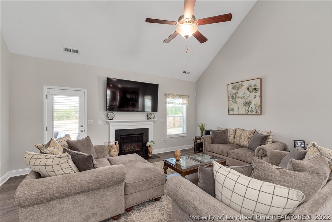 162 Trinity Road Raeford, NC 28376 - Photo 5 of 33 a living room with furniture a fireplace and a flat screen tv