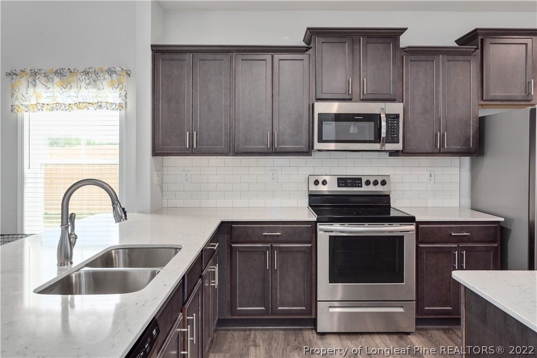 162 Trinity Road Raeford, NC 28376 - Photo 8 of 33 a kitchen with stainless steel appliances granite countertop a stove a sink and a microwave
