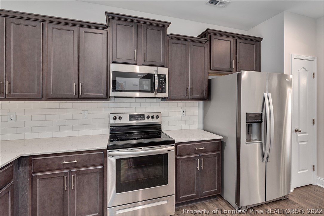 162 Trinity Road Raeford, NC 28376 - Photo 9 of 33 a kitchen with a refrigerator stove and microwave