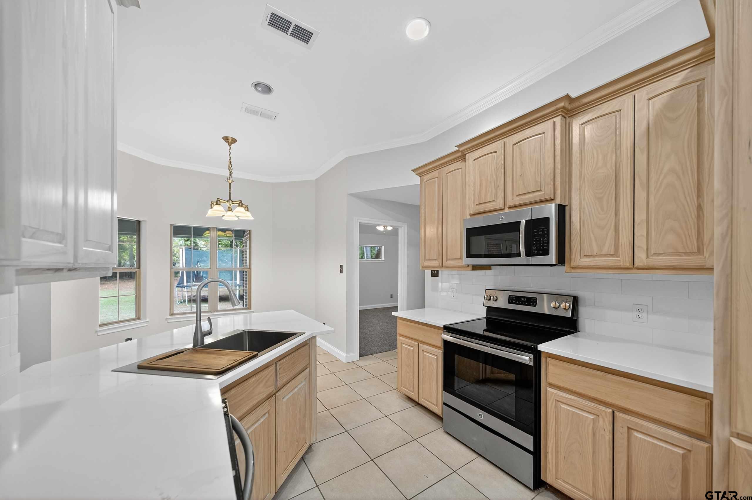 21112 Altuda Lane Flint, TX 75762 - Photo 8 of 48 a kitchen with stainless steel appliances granite countertop a sink a stove and a refrigerator