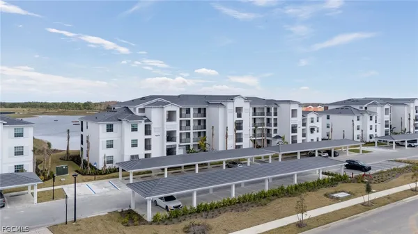 a city view with tall buildings and cars parked in front of it