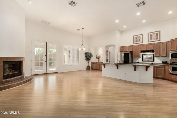 a view of a living room kitchen and a fireplace