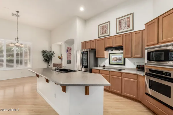 a kitchen with stainless steel appliances a sink stove and cabinets