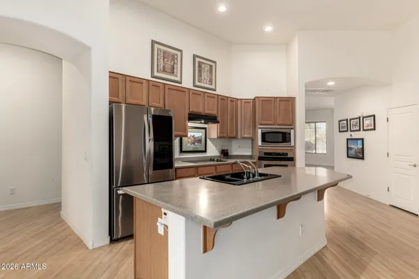 a kitchen with stainless steel appliances a refrigerator and a stove top oven