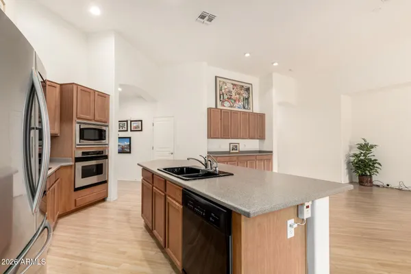 a kitchen with stainless steel appliances granite countertop a refrigerator and a stove