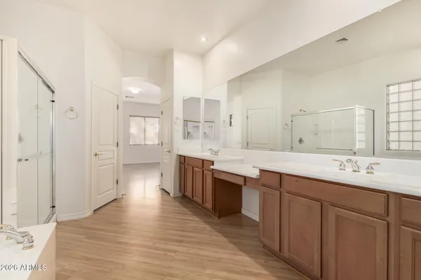 a large kitchen with a lot of counter space and wooden floor