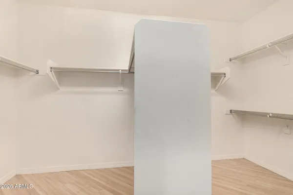 a view of walk in closet with empty racks