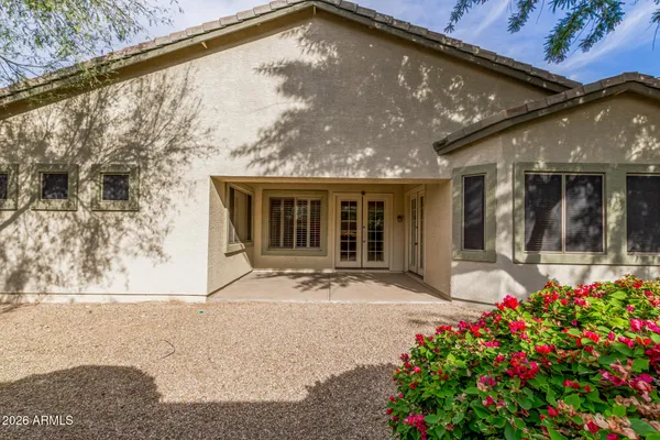 a front view of house with flowers