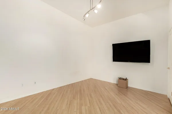 a view of a livingroom with wooden floor and a flat screen tv