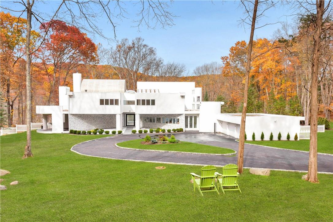 a swimming pool with outdoor seating and yard