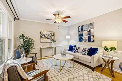 a living room with furniture and a chandelier