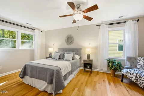 a spacious bedroom with a bed and a table