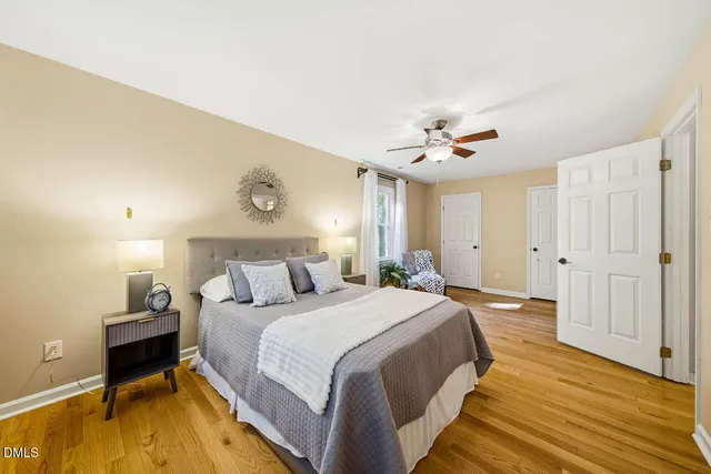 a spacious bedroom with a bed and a chandelier