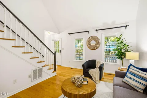 a living room with furniture and a wall painting