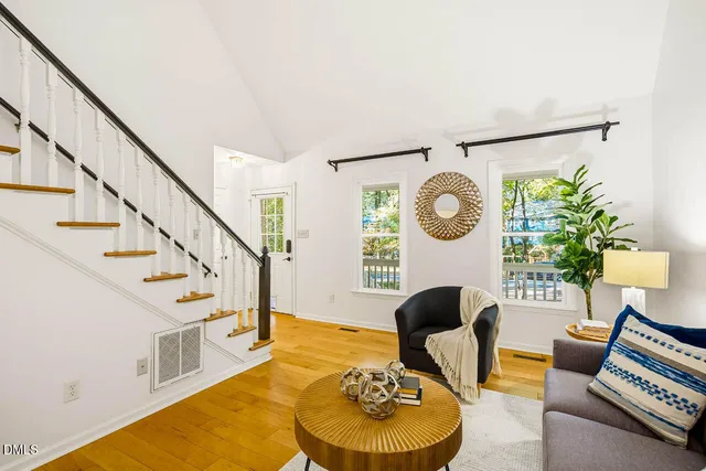 a living room with furniture and a wall painting