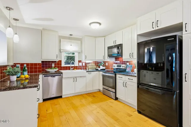a kitchen with a sink cabinets and stainless steel appliances