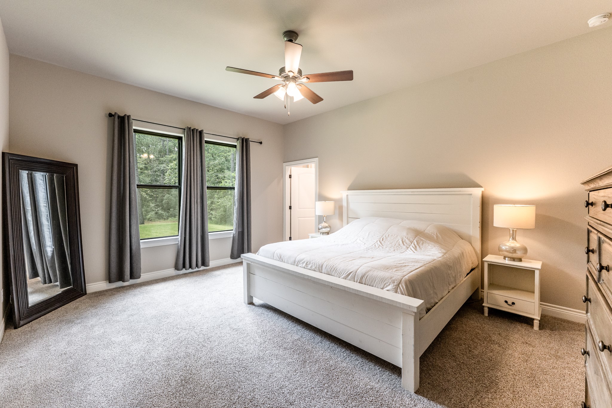 111 Eagle Run Road Willis, TX 77378 - Photo 18 of 44 Spacious and serene primary bedroom with abundant natural light and lush views.