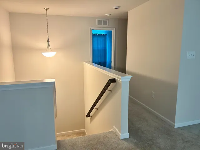 a view of a hallway with stairs