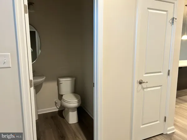 a white toilet sitting next to a bathroom sink