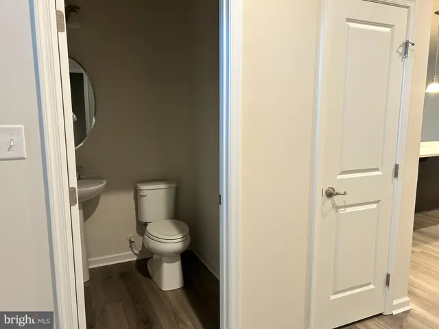 a white toilet sitting next to a bathroom sink
